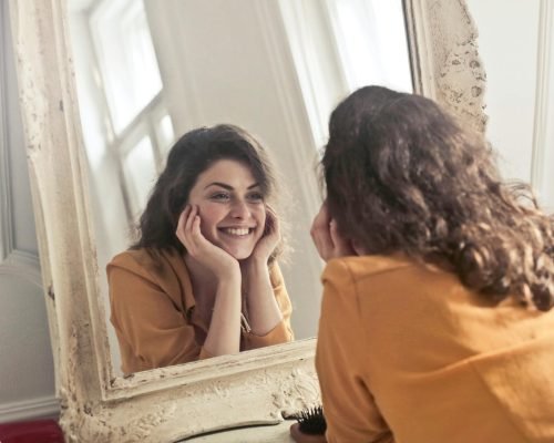 Photo of Woman Looking at the Mirror